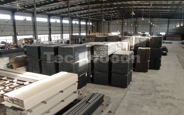Stacks of WPC profiles stored inside the Techwoodn factory